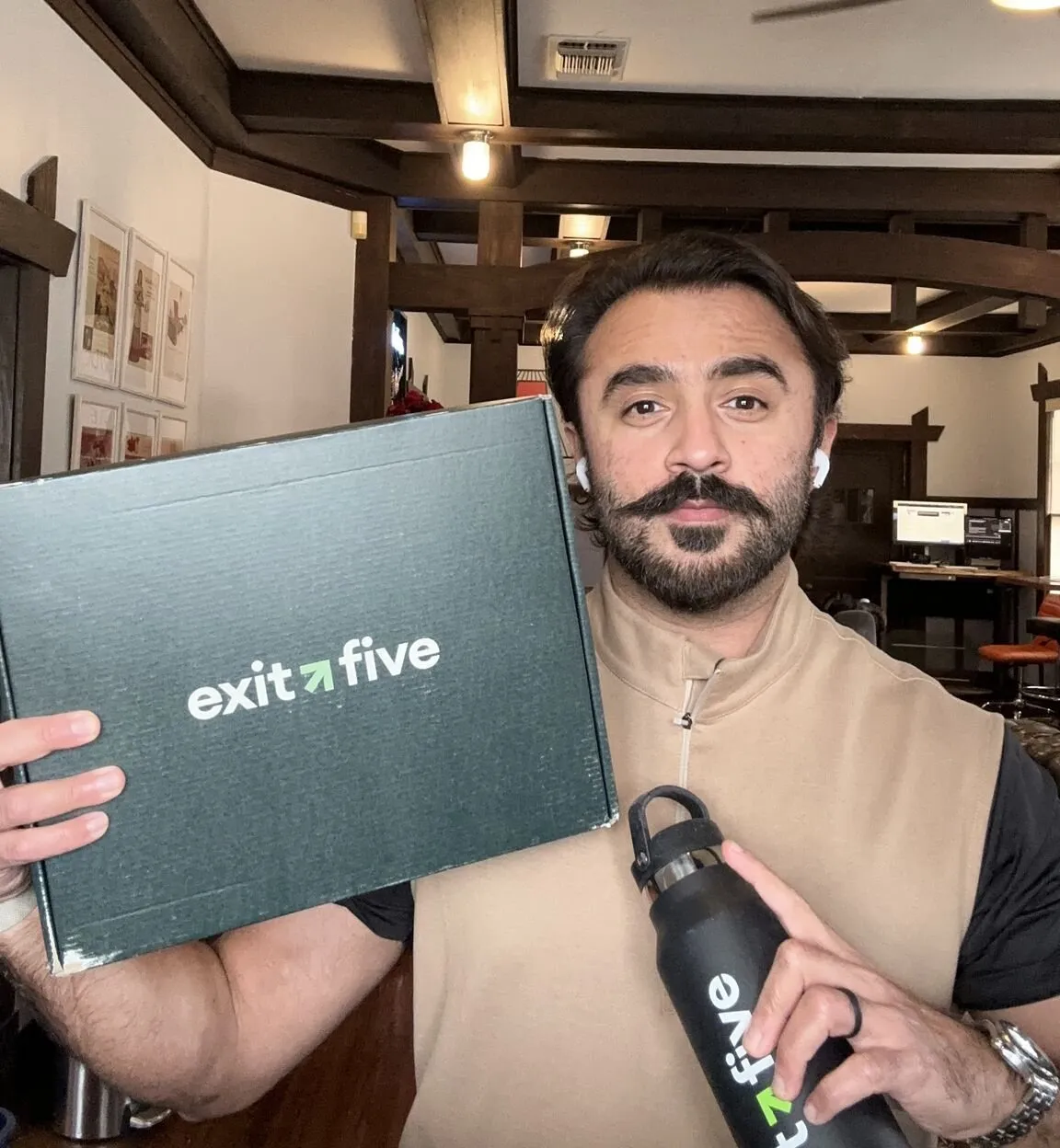 Moby holding up an Exit Five box